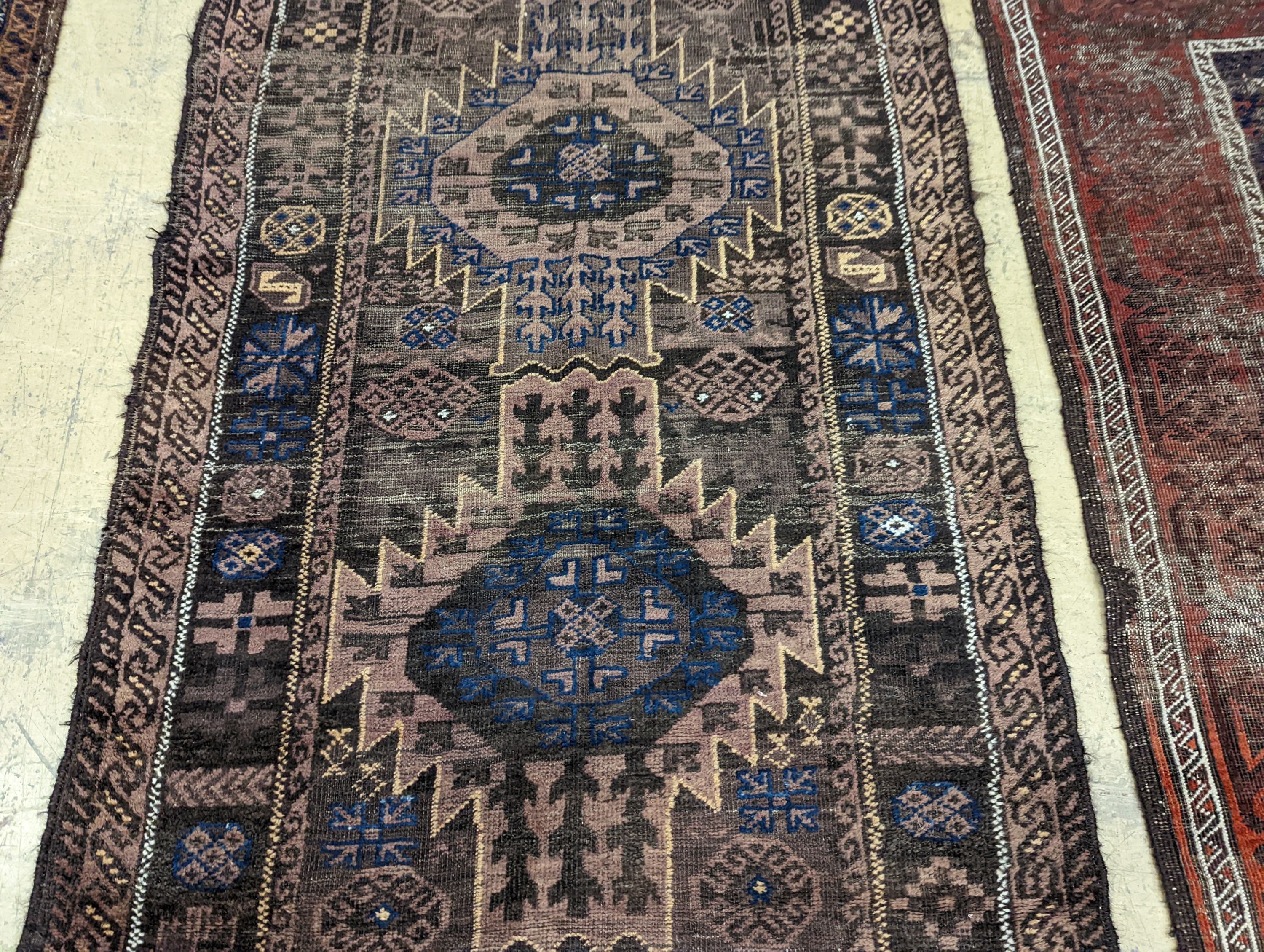 Two Caucasian geometric polychrome rugs, largest 190 x 96cm